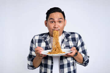 Happy young Asian man in casual shirt enjoying eating noodles with fork isolated on white background