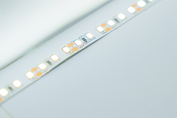 LED strip light on a white table. Modern lighting.