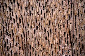 Perforated wood texture with stones in the cavity