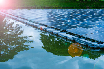 Side view of solar panels floating on water in a lake, for generating electricity from sunlight, selective focus, soft focus.