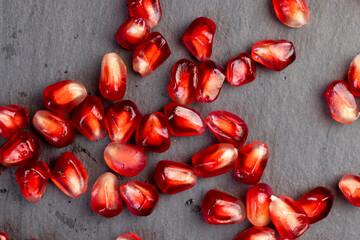 Peeled red pomegranate with ripe grains