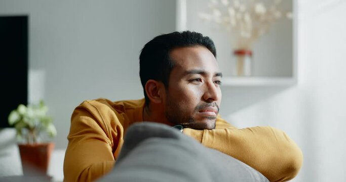 Thinking, memory and sad asian man on a sofa with nostalgia, depression or grief in his home. Burnout, worry and Japanese male in living room with broken heart, mourning or anxiety for loss and debt
