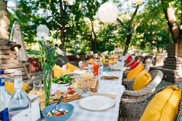 A festive table is served in the park or in the garden. 
