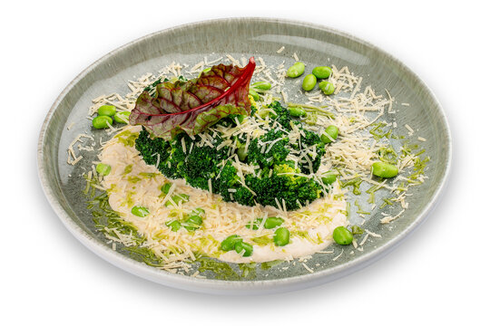 Steamed broccolli with white sauce and beans. Isolated image on a white background.