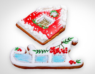 New Year's gingerbread in the shape of a house and a sleigh. A festive treat. Isolated on a white background.