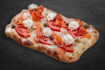 Philadelphia pizza with salmon, shrimps, tomatoes, mozzarella, capers, Philadelphia cheese. Roman...