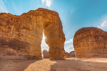 Jabal AlFil - Elephant Rock in Al Ula desert landscape, bright sun creates sunrays behind