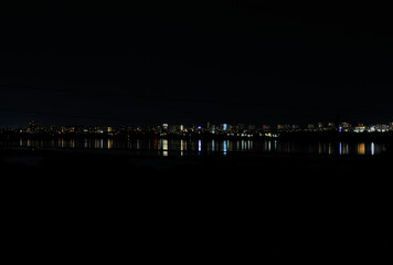 Fototapeta na wymiar night city of Burgas landscape reflected in Lake Atanasovo