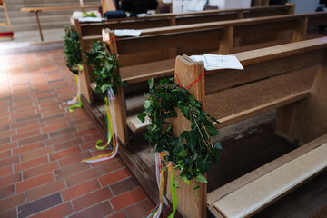 Church pews decorated for a wedding in Germany