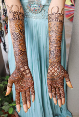 he Bride displays decoration of her hands with Henna Mehndi designed in Arabic style during a Wedding ceremony in India.