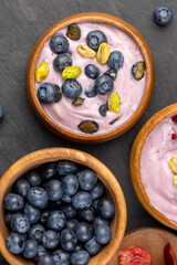 fresh blueberry-flavored yogurt with ripe blueberries and pistachios