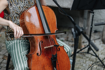 Woman playing the cello outdoors at a concert close-up