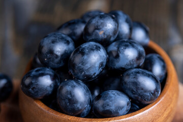 Unwashed blue grapes in the dust