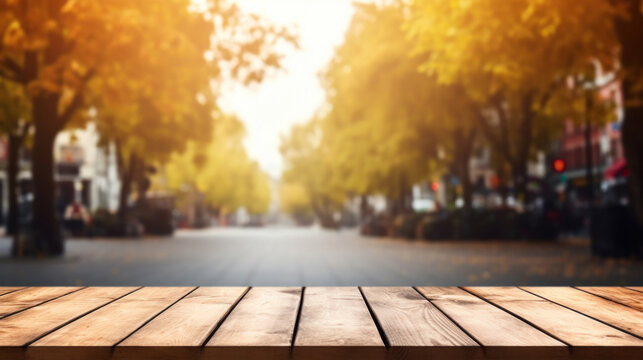 Empty wooden table top with blur background of city street in autumn
