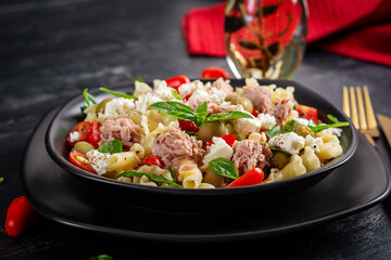 Pasta with tuna, tomatoes and feta cheese. Pasta salad with tuna. Healthy italian food. Healthy dinner.