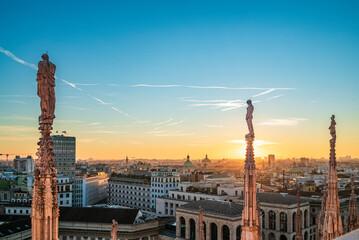 As the sun begins its descent below the horizon, the city of Milan undergoes a breathtaking transformation