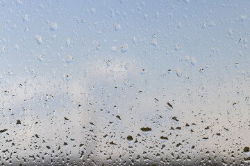 glass covered with rain water drops in a building window