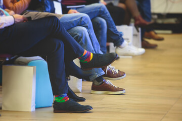 Speakers shoes at the business conference event, audience at the lecture hall listens to lecturer, persons on a stage at master-class, corporate business congress seminar at the venue