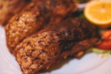 Fried grilled carp, roasted carp fish on plate with lemon and salad served in a traditional restaurant in Montenegro, Skadar lake, prepared cooked crucian carp steak, balkan dish, Montenegrin cuisine