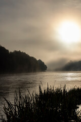Fototapeta na wymiar A little fog on the river in autumn