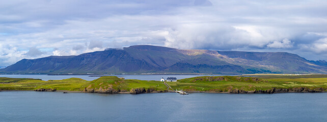 Panoramic view of typical scenic landscape in Iceland with pastures near fjords and glaciers.
