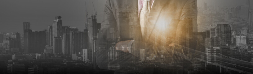 Double exposure smart businessman standing arm cross and thinking outside, with sunlight and cityscape background, concept idea business, finance and investment development, panoramic header banner.