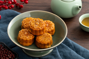 Delicious Cantonese moon cake for Mid-Autumn Festival food mooncake on wooden table background.