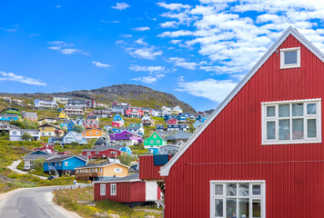 Typical architecture of Greenland city Qarqotoq with colored houses located near fjords and icebergs. - obrazy, fototapety, plakaty