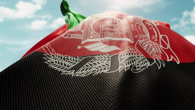 Wavy flag of Afghanistan blowing in the wind in slow motion. Waving colorful Afghanistan flag symbol abstract vertical background. Sun and blue sky with clouds on a background