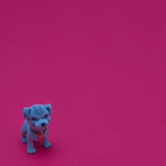 A blue dog in the lower left corner on a red background. Minimal love pets scene.