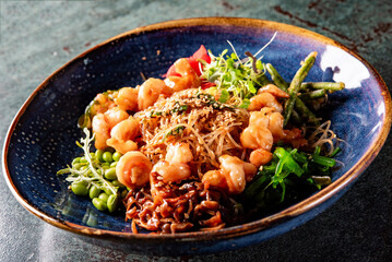 Salad with funchoza, shrimp and vegetables in restaurant
