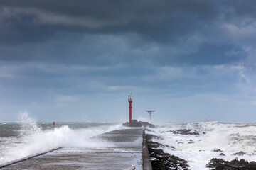 Stormy weather at the pier of Hoek van Holland, a seaside and port town along the Dutch coast near...