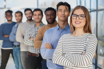 Fototapeta premium Portrait of multicultural office staff standing in the lobby in a row