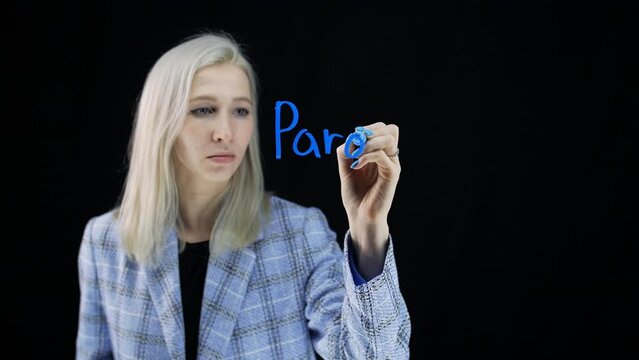 Parathreads is a word written on a black background. A girl with blonde hair writes a word with a blue marker.