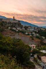 Sunset over the clock tower and fortress of Gjirokaster, Albania