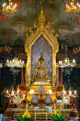 Fototapeta premium The principal Buddha image in the church of Wat Pathum Wanaram located in the center of Bangkok Close to the tourist attraction Siam Square.