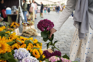 Woman selecting fresh flowers at the farmers' market