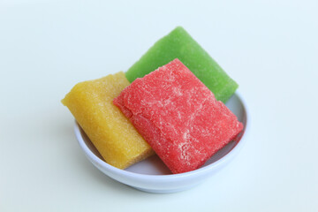 Yangko is traditional snack from Yogyakarta, Indonesia. Made from glutinous rice powder. Colorful yangko on plate plate, isolated on white background