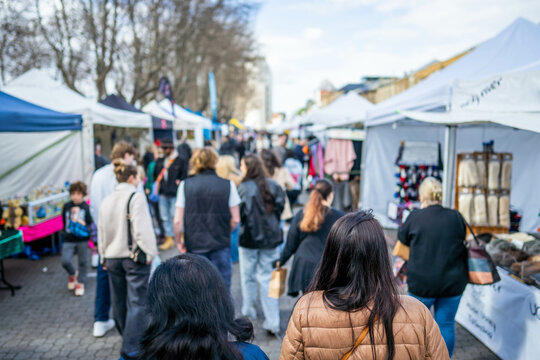 people shopping in a weekend market in a city