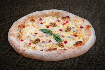 Pizza Four Cheese with smoked suluguni, gorgonzola, mozzarella, mountain ash, walnuts, honey, basil. Neapolitan round pizza on wood background