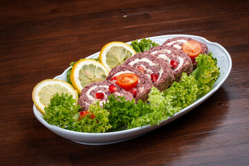 Roll with red beans, nuts and butter. Armenian cuisine. In a takeaway package. Isolated on a dark background