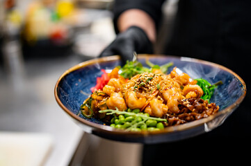 chef cooking Salad with funchoza, shrimp and vegetables