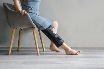 Female leg in knee brace. Injury, medicine, arthritis and meniscus diseases concept.