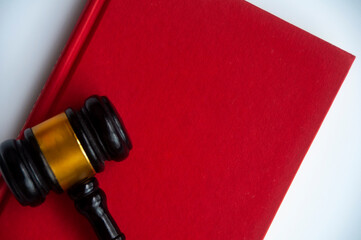 Top view of empty cover red book with gavel.