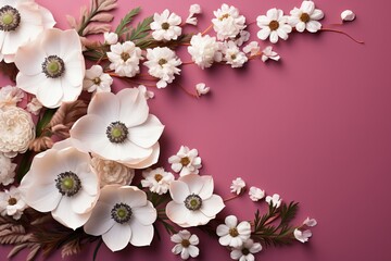Obraz na płótnie Canvas Several white and pink flowers - anemones, daisies and branches on a seamless pastel pink background. Top view. Flat lay. Copy space for text.