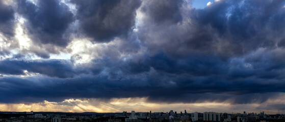 Dawn clouds over the metropolis of early winter sunset