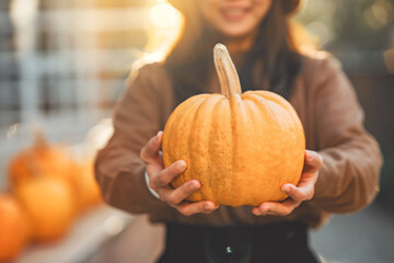Close up Woman holding a pumpkin in her hands for Halloween