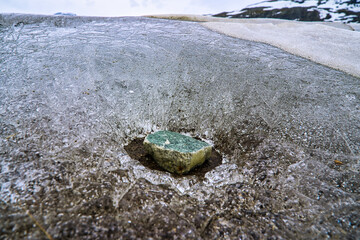 Under pressure(of a stone) melted ice at Stordalsvatnet, a lake in Nordland. It is located near the hamlet of Storbørja and the village of Almlia