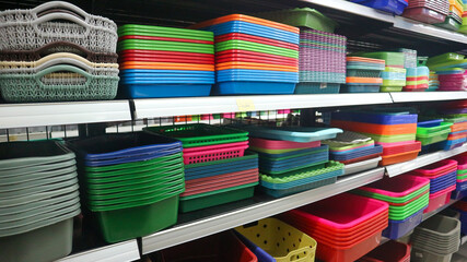 food storage containers and kitchen utensils on supermarket shelves for sale