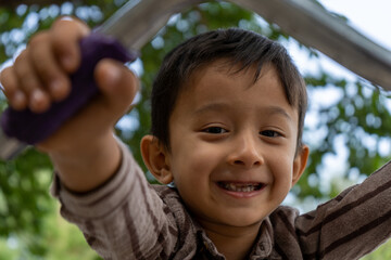 Portrait of confident boy sitting on bicycle